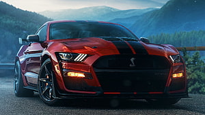 Red Ford Mustang Shelby GT500 with Black Stripes on Mountain Road HD wallpaper