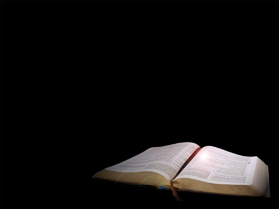 Open Bible Book Illuminated by Light on Black Background HD wallpaper