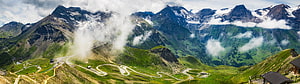 Panoramic Alpine Mountain Range With Winding Road And Snow-Capped Peaks HD wallpaper