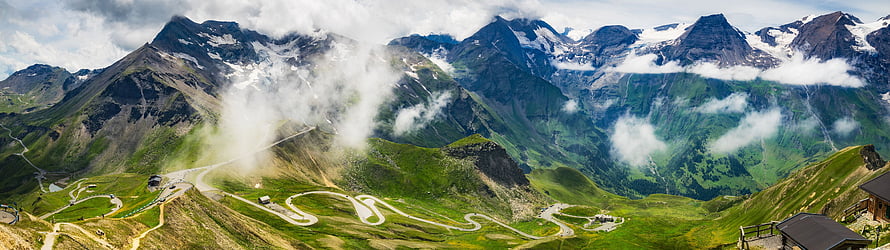 Panoramic Alpine Mountain Range With Winding Road And Snow-Capped Peaks HD wallpaper