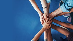 Group of Diverse Hands Stacked Together in a Circle of Unity and Collaboration HD wallpaper
