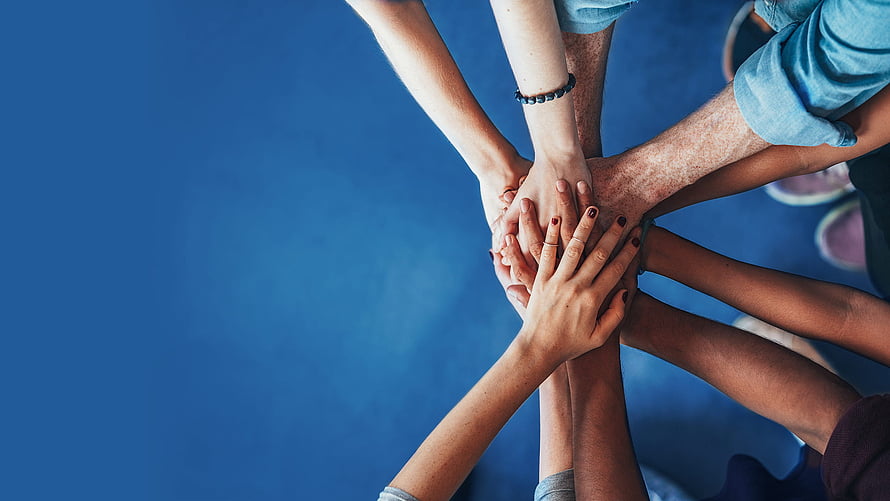 Group of Diverse Hands Stacked Together in a Circle of Unity and Collaboration HD wallpaper