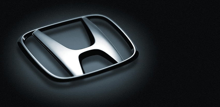 Sleek Chrome Honda Emblem on Dark Matte Surface HD wallpaper
