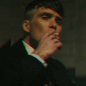 Tommy Shelby Smoking a Cigarette in a Dark Suit with Dramatic Red and Green Lighting HD phone wallpaper
