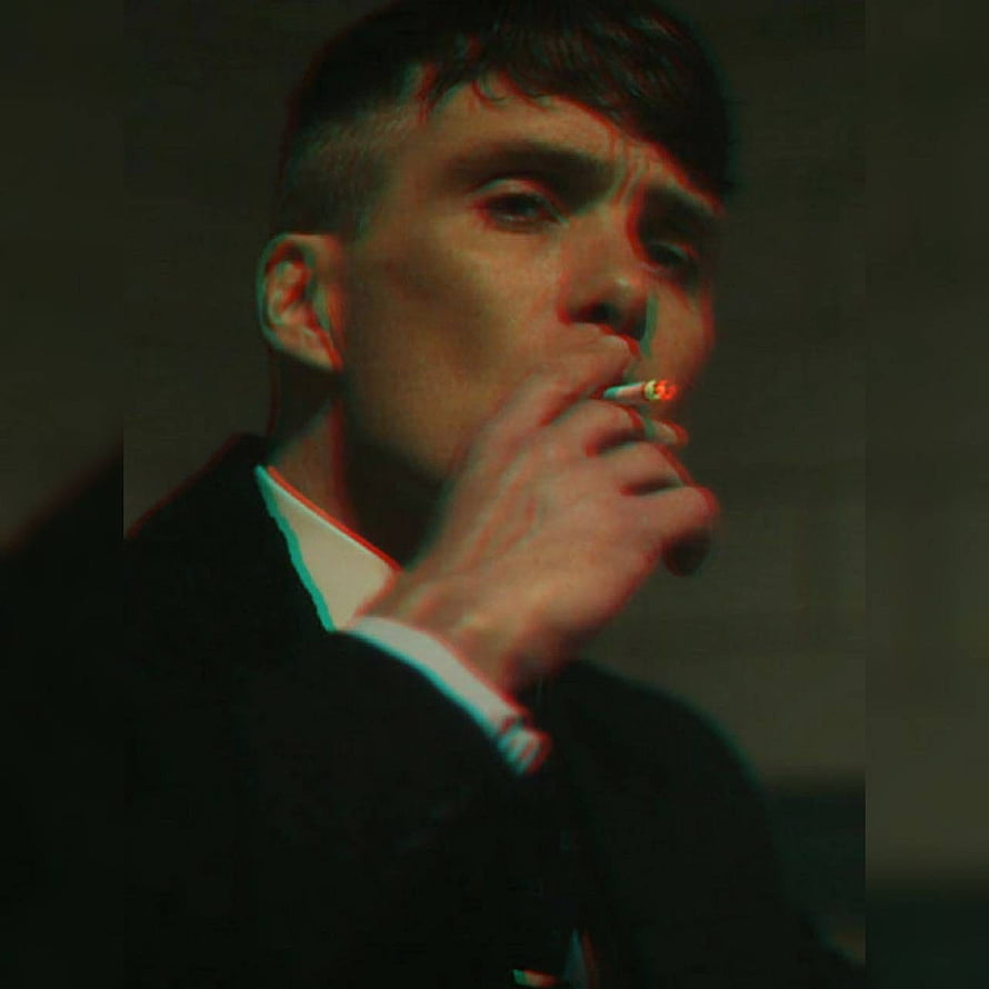 Tommy Shelby Smoking a Cigarette in a Dark Suit with Dramatic Red and Green Lighting HD phone wallpaper