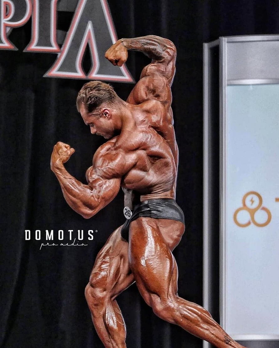 Muscular Male Bodybuilder Flexing Back Pose On Stage HD phone wallpaper