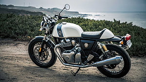 Royal Enfield Continental GT 650 parked on a coastal dirt path with ocean cliffs in the background HD wallpaper