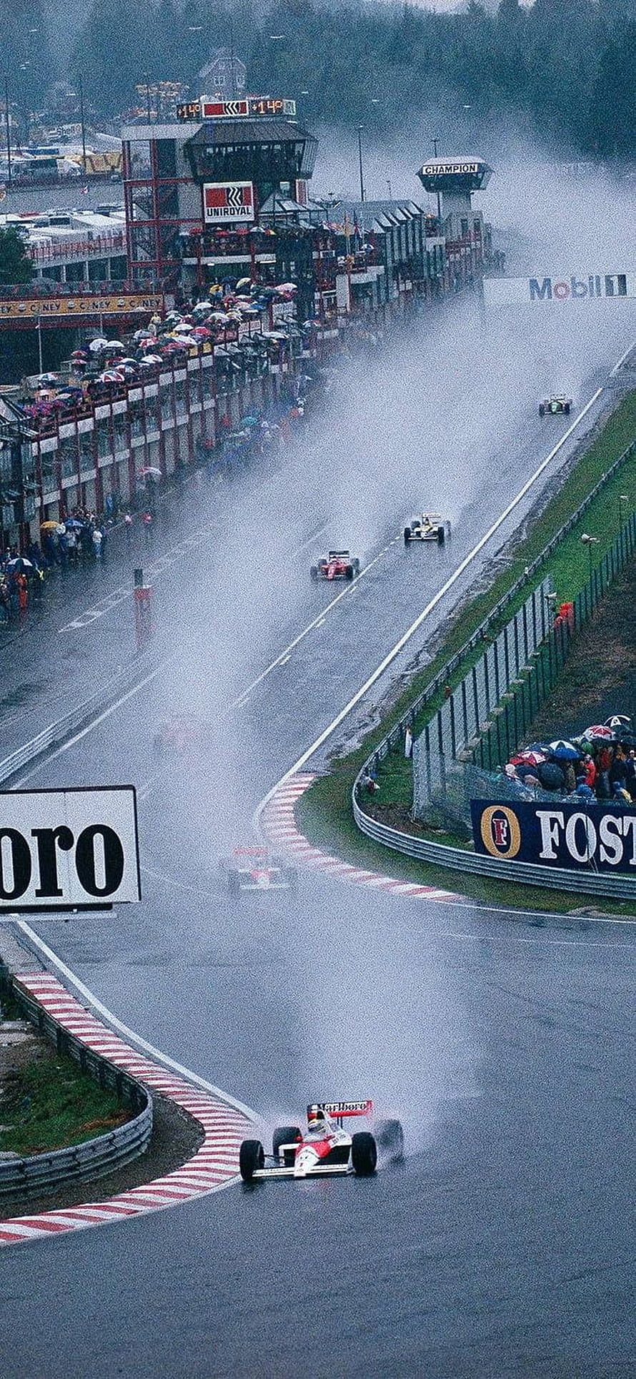 Classic Formula 1 race at Spa-Francorchamps in heavy rain with spray and spectators HD phone wallpaper