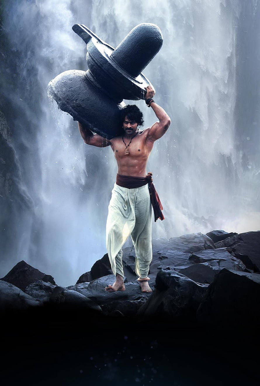 Powerful Warrior Carrying Heavy Stone Mortar in Front of Majestic Waterfall HD phone wallpaper