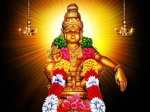 Golden Lord Ayyappa Statue with Flower Garlands and Oil Lamps HD wallpaper