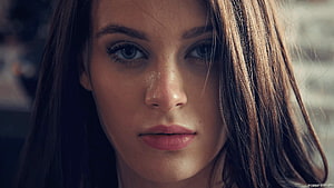 Close-up portrait of a beautiful woman with blue eyes and brown hair looking directly at the camera with a serious expression, Lana Rhoades HD wallpaper