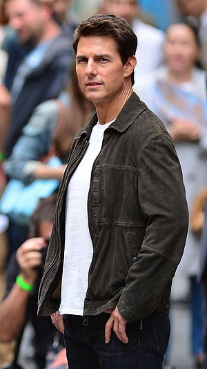 Tom Cruise in a dark jacket and white t-shirt at a public event HD phone wallpaper