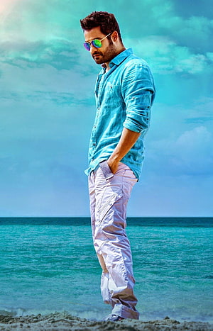 Jr NTR in Turquoise Shirt and Sunglasses Standing on a Beach HD phone wallpaper