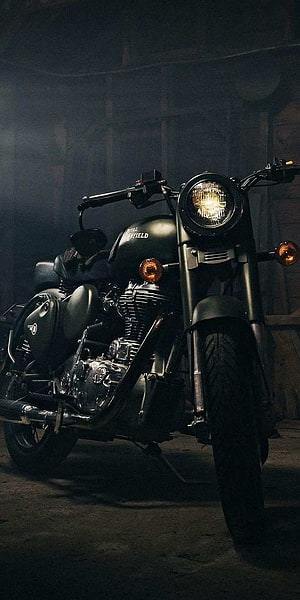 Black Royal Enfield Classic 350 Motorcycle in Dark Garage Setting HD phone wallpaper