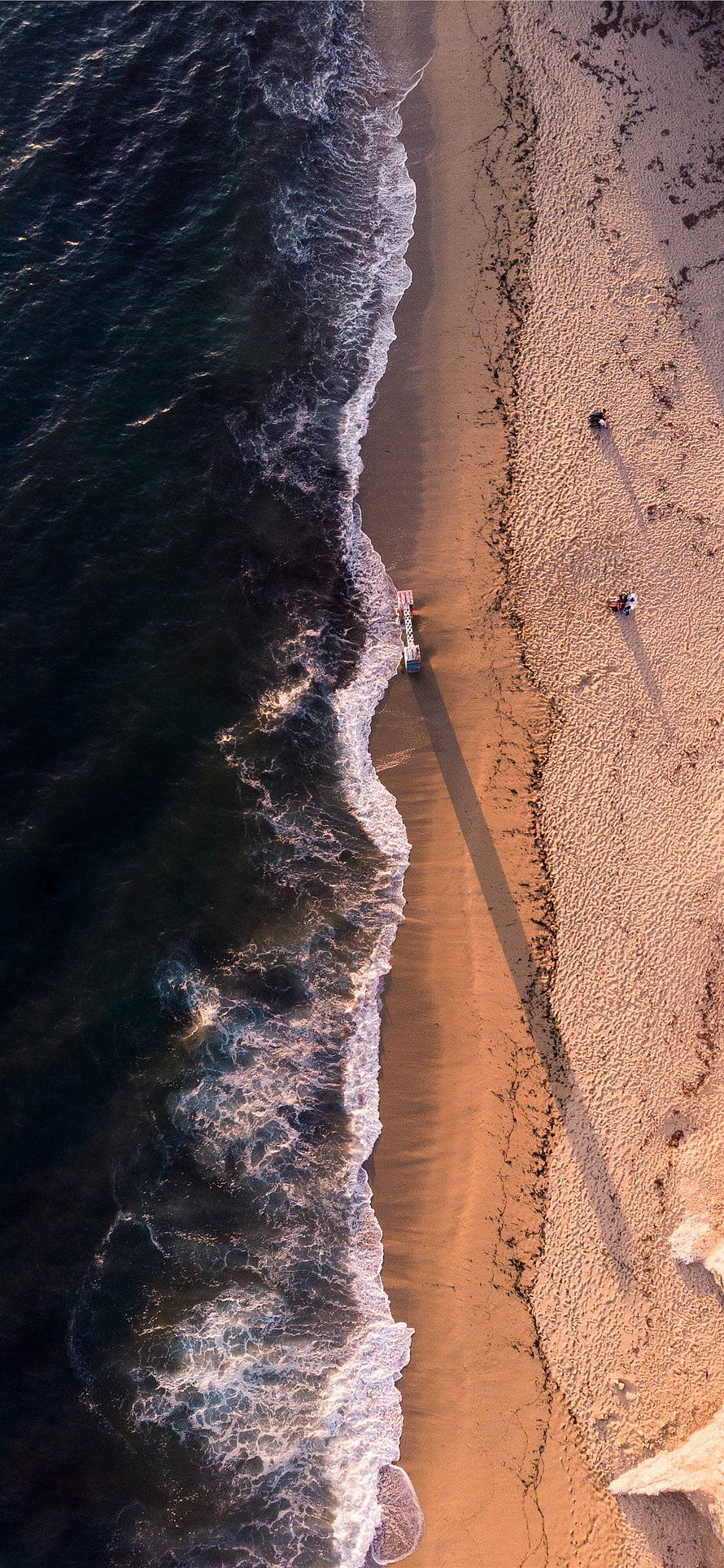 Aerial View of Ocean Waves Crashing on Sandy Beach with Lifeguard Tower HD phone wallpaper