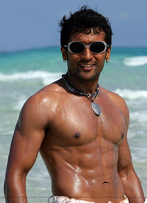 Surya shirtless beach portrait with sunglasses and beaded necklace HD phone wallpaper