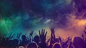 Silhouette of a cheering crowd with raised hands under a vibrant cosmic starry sky HD wallpaper
