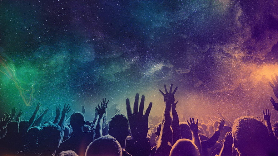 Silhouette of a cheering crowd with raised hands under a vibrant cosmic starry sky HD wallpaper