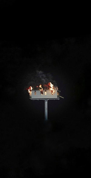 Elevated Structure Enveloped in Flames Against a Dark Night Sky HD phone wallpaper