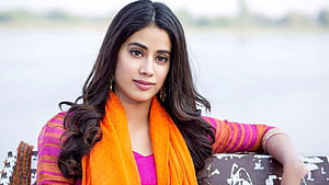 Janhvi Kapoor in vibrant orange dupatta and pink striped kurta by a serene lake HD wallpaper
