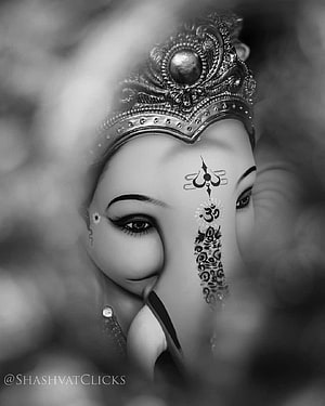 Black and white portrait of Lord Ganesha with intricate forehead markings and ornate crown HD phone wallpaper