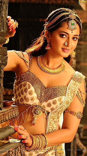 Anushka Shetty in ornate gold jewelry and traditional Indian costume from Baahubali 2 HD phone wallpaper