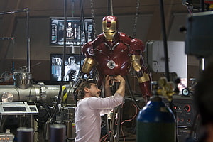 Tony Stark Assembling The Iron Man Armor In A High-Tech Workshop, Tony Stark, iron man suit up HD wallpaper