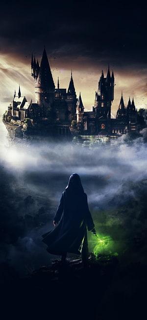 Hooded Wizard Casting Green Spell Before Hogwarts Castle in Misty Fog HD phone wallpaper