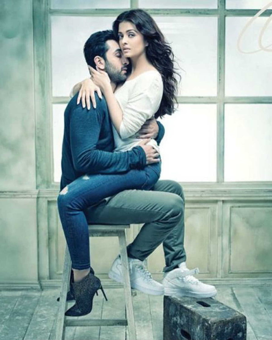 Ranbir Kapoor and Aishwarya Rai in an intimate embrace against a bright window backdrop HD phone wallpaper