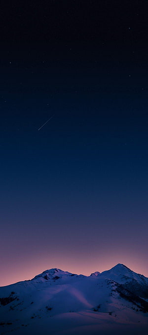 Snowy Mountain Peaks Under a Starry Night Sky with a Shooting Star HD phone wallpaper