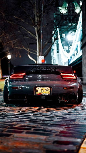 Rear View of a Modified JDM Sports Car on a Cobblestone Street at Night HD phone wallpaper