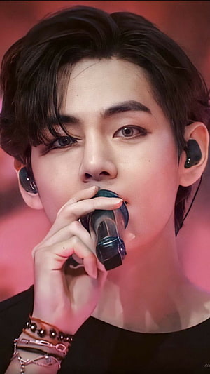 V from BTS performing on stage with microphone and in-ear monitors HD phone wallpaper