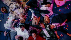 Stray Kids Members Lying Down in Vibrant Neon Lighting with Colorful Confetti HD wallpaper
