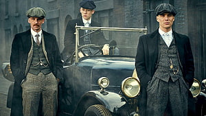 Peaky Blinders Gang Members in Vintage Suits Standing Beside a Classic Car in a Gritty Urban Setting HD wallpaper