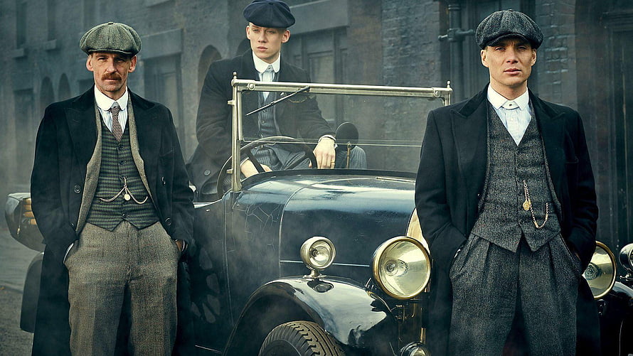 Peaky Blinders Gang Members in Vintage Suits Standing Beside a Classic Car in a Gritty Urban Setting HD wallpaper