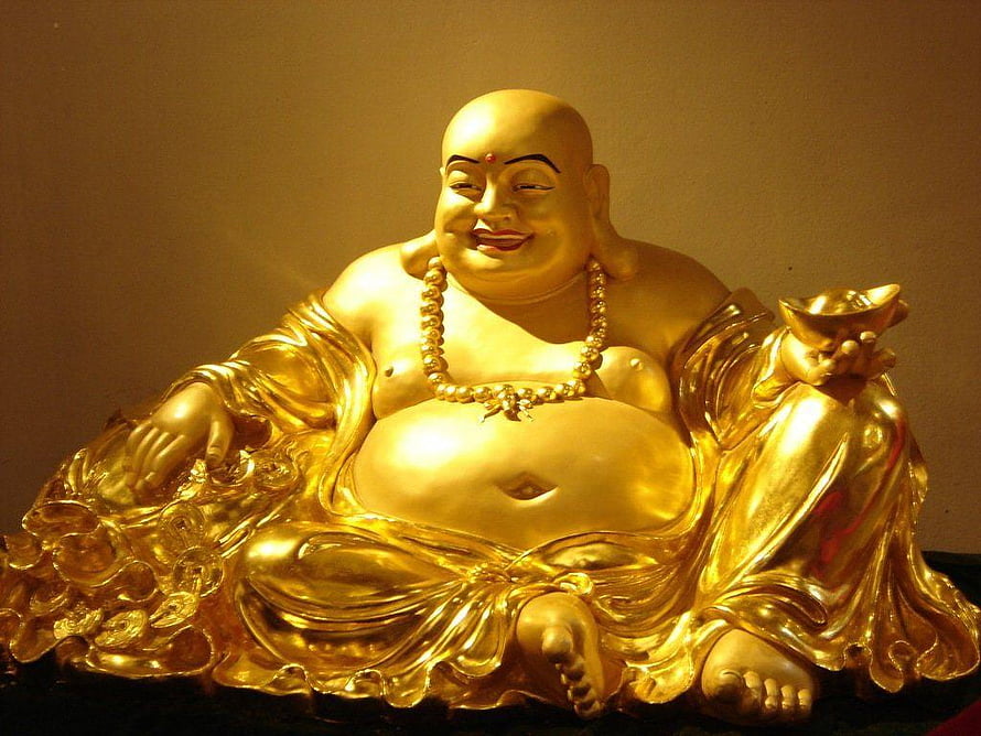 Golden Laughing Buddha Statue Holding Gold Ingot and Coins HD wallpaper