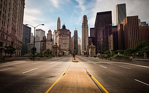 Empty Manhattan Avenue with Skyscrapers and Historic Architecture Under a Blue Sky HD wallpaper