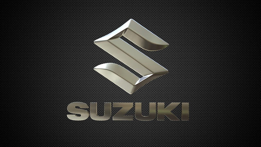 Suzuki Metallic Logo on Dark Carbon Fiber Background HD wallpaper