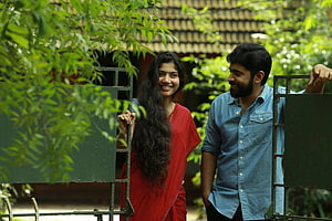 Premam Movie Still Featuring Manju Warrier and Dusharanthan in a Lush Garden Setting HD wallpaper