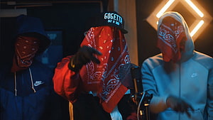 Three masked rappers performing in a studio with neon lights and bandanas HD wallpaper