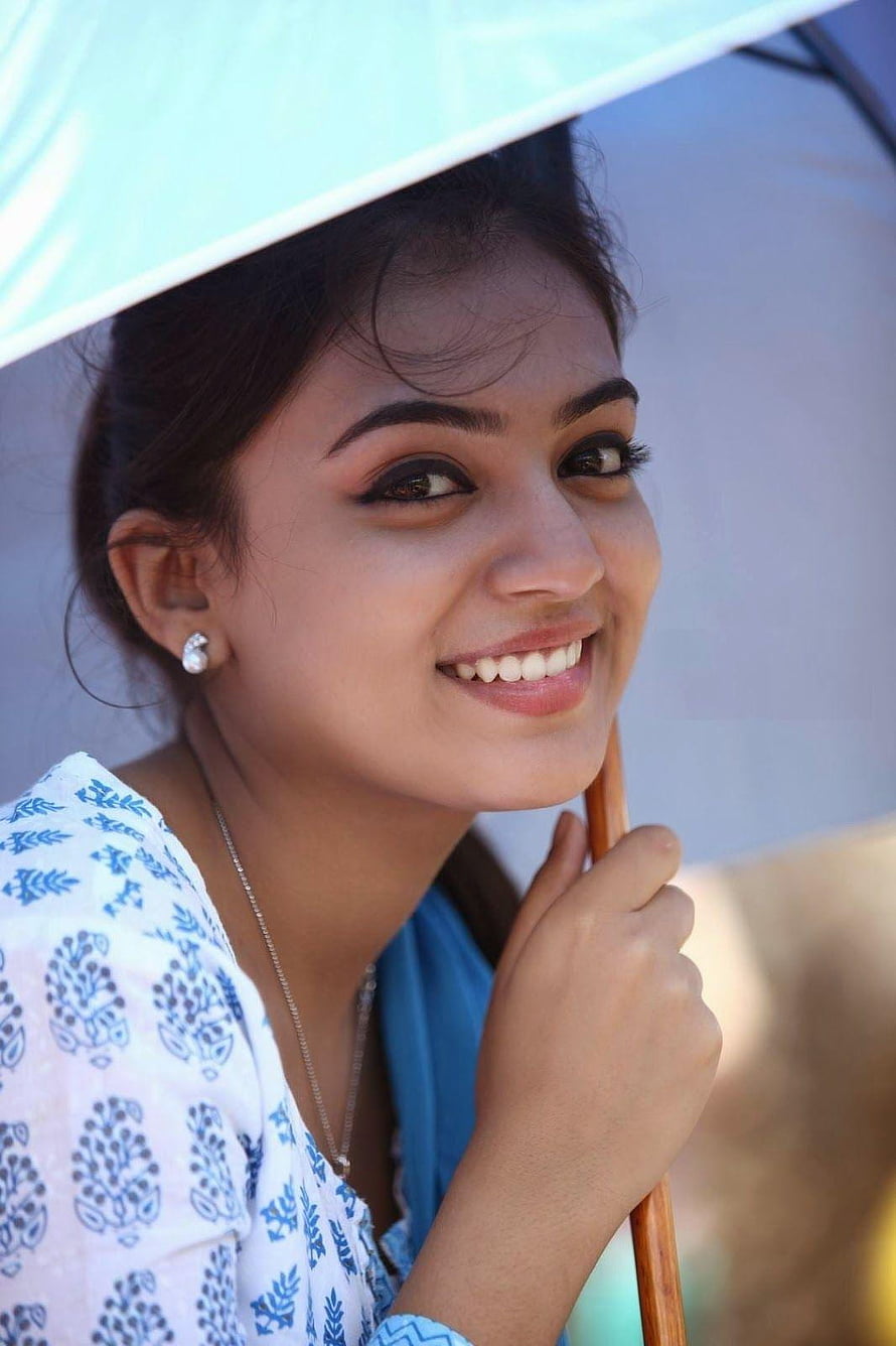 Nazriya Nazim smiling portrait under a light blue umbrella with floral top and pearl earring HD phone wallpaper