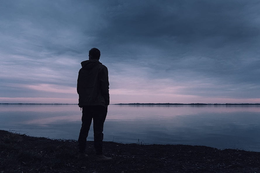 Silhouette of a man standing alone on a lakeshore at dusk under a moody overcast sky, Sad Pic Of Boy In Love: Best Broken Heart, heartbroken boy HD wallpaper