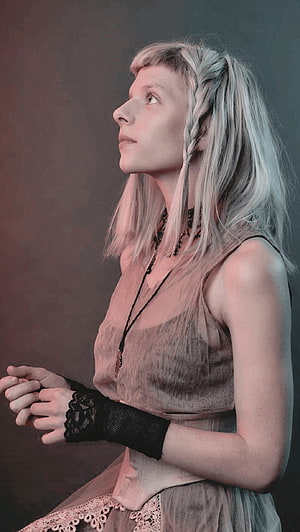 Aurora Aksnes in a moody profile portrait with silver hair and lace accessories HD phone wallpaper