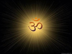 Glowing Om Symbol With Radiant Golden Light Rays On Black Background HD wallpaper