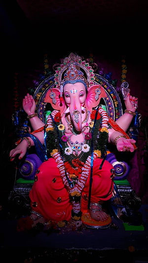 Vibrant Ganesha Idol Adorned with Jewels and Floral Garlands HD phone wallpaper