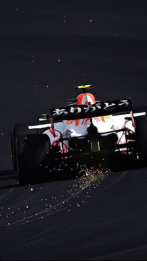 Red Bull Racing Formula 1 car with Japanese thank you message on rear wing HD phone wallpaper