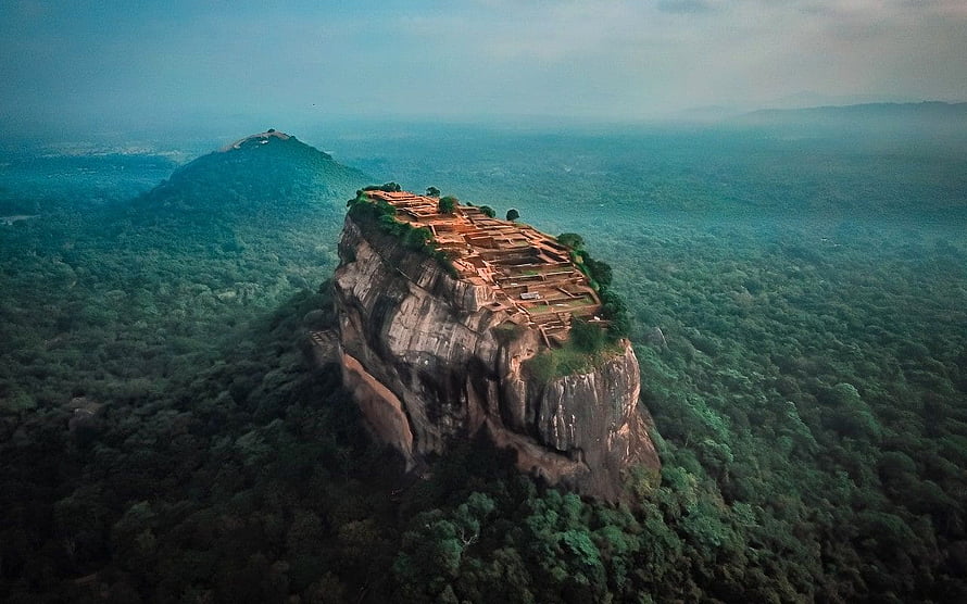 Aerial View of Sigiriya Rock Fortress Rising Above Lush Sri Lankan Jungle Canopy HD wallpaper