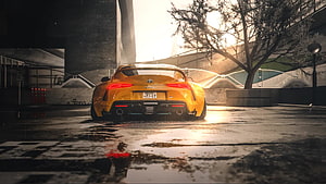 Yellow Toyota Supra Rear View on Wet Street at Sunset HD wallpaper