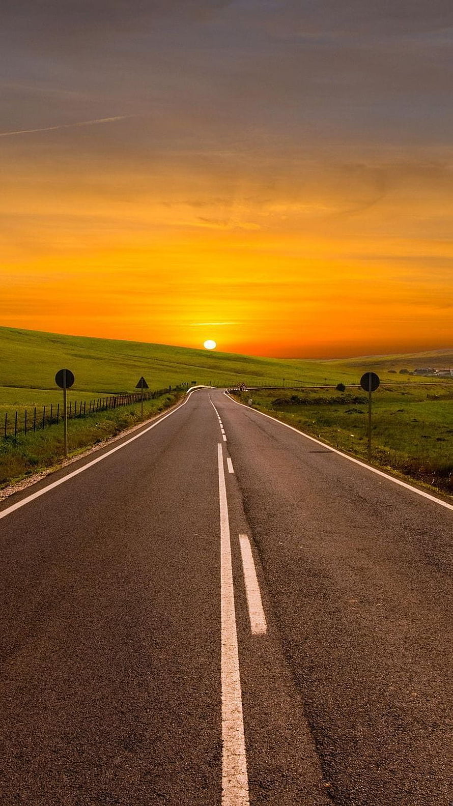 Sunset Over Rolling Green Hills With A Winding Country Road HD phone wallpaper