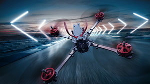 FPV Racing Drone in Motion on a Neon-Lit Track at Dusk HD wallpaper
